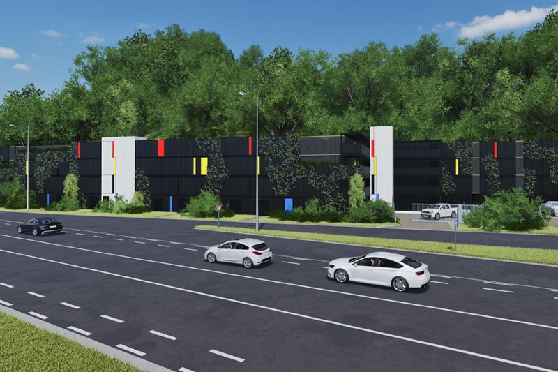 Façade du futur centre de self-storage Secutainer vue de la route, bardage noir et bandes colorées